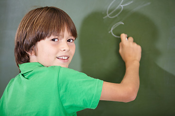Image showing Portrait, happy and boy writing on a chalkboard for child development, confidence and art for learning. Academic, creative and kid student drawing in the classroom with face, school and answers