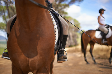 Image showing People, horses and countryside for horseback riding in texas, strong and sport training. Farm, feet and stirrup in outdoor, adventure and animal livestock with jockey, pet care and dirt road