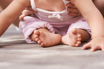 Image showing Youth, baby feet and family hands with love, bonding and child care with parenting and outdoor. Together, support and kid with newborn, holding and barefoot with trust, toddler and relax with parent