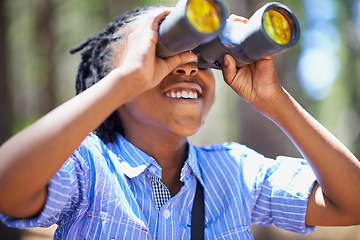 Image showing Binocular, search and boy child in a forest for hiking, sightseeing or discovery. Lens, equipment and happy African kid in nature for adventure, learning or seeing, explore or watching while camping