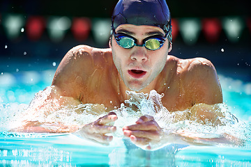 Image showing Man, swimming pool and training for sport with splash, speed and exercise for wellness, health and fitness. Swimmer, athlete or person in water for games, contest or workout with goggles in summer