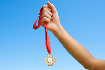 Image showing Gold medal, sky and hands of sports person winning award, competition victory or game in outdoor contest. Marathon champion, triathlon winner or closeup athlete with prize, success and achievement