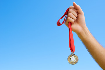 Image showing Gold medal, blue sky and hands of sports person winning award, competition victory or game contest. Race champion, challenge winner and closeup athlete with mockup space, success or prize achievement