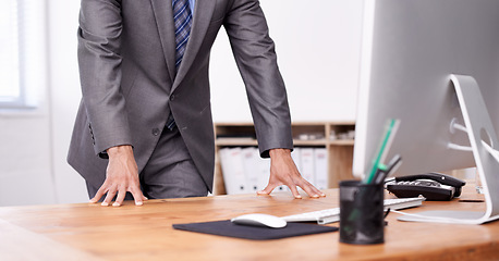 Image showing Businessman, office and standing at desk, computer and corporate wear for business, boss and career. Leadership, management and strategy for company, workplace and manager with suit and formal