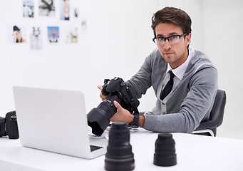 Image showing Man, photographer and portrait with laptop, camera and lens for work, shoot and editing photographs. Professional, office and technology with creativity, internet and equipment for videography