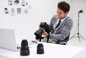 Image showing Man, camera and photography in office with happy smile, checking image batch and creative in workplace. Person, thinking and glasses for vision, technology and editor in agency for digital photoshoot