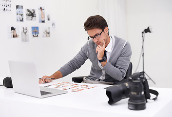 Image showing Photographer, editing and thinking with computer in office with media, process and production. Professional, editor and creative person with choice on laptop with photoshoot results or cinematography