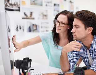 Image showing Computer, office and photographers looking at photoshoot in a studio or workshop for production. Creative, photography and team of young artists with dslr equipment and desktop for picture inspection