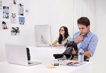 Image showing Camera, man and photographer with photoshoot for quality control in a studio or workshop for production. Creative, photography and artist with dslr equipment for picture inspection in modern office.