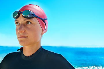 Image showing Swimmer sport, face and woman at ocean outdoor in summer for exercise, thinking of training or vision. Sea, athlete and person in goggles for fitness, health or idea at beach water on mockup space