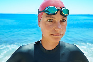 Image showing Swimmer sport, face and woman at sea outdoor in summer for exercise, training or workout. Ocean, athlete and person in goggles in nature for fitness, health or triathlon competition at beach water