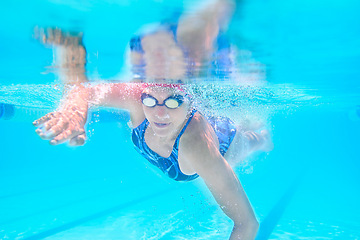 Image showing Sports, underwater or woman in swimming pool for workout, competition training or energy in gala. Fitness, female swimmer and fast athlete diving for cardio exercise, championship and race practice