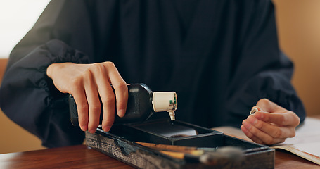 Image showing Black ink, calligraphy or hands of Japanese artist in studio for art and script, letter with closeup for alphabet. Start, ready or person with tools, paintbrush and focus with traditional stationery