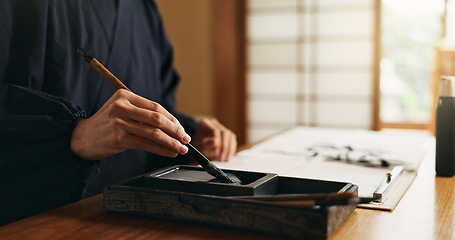 Image showing Hands, reed pen or brush in ink for writing, calligraphy or ancient script for art and inkstone. Japanese creativity, black paint and vintage tools, paintbrush and stroke, traditional and stationery