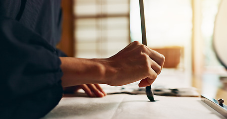 Image showing Hands, brush for writing and ancient script for art, calligraphy and closeup with alphabet. Japanese, creativity and vintage tools, paintbrush and stroke with traditional stationery and font