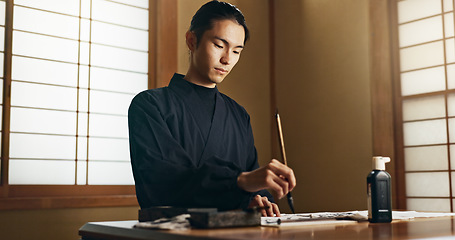 Image showing Calligraphy, ink and traditional Japanese man with paper for letters, notes and text for documents or script. Creative, writer and person with paintbrush, tools and desk for art, writing and culture