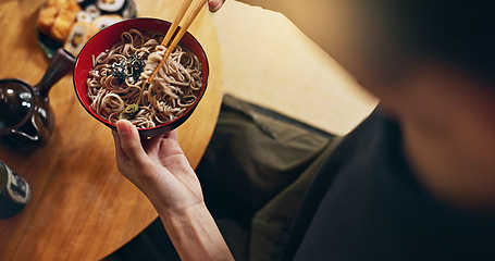 Image showing Closeup of bowl of noodles, hands and person is eating food, nutrition and sushi with chopsticks in Japan. Hungry for Japanese cuisine, soup and Asian culture, traditional meal for lunch or dinner