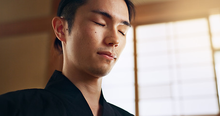 Image showing Thinking, zen and young Asian man with meditation, calm and relaxing face expression at home. Idea, mindfulness and male person with memory, reflection and breathing exercise in modern apartment.