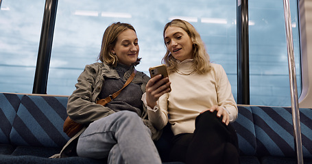 Image showing Happy woman, friends and phone on train for social media, communication or networking in public transport. Female person or people talking with mobile smartphone for online search on railway ride