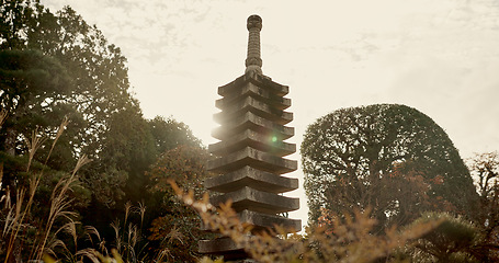 Image showing Japanese temple, culture and sculpture in garden for zen, mindfulness or peace with trees in nature. Spiritual, Asian architecture and concrete structure with plants in forest or woods in morning