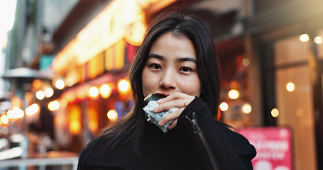 Image showing Travel, eating and Asian woman with onigiri in the city on exploring vacation, adventure or holiday.Portrait, food and young female person enjoying a Japanese snack or meal in town on weekend trip.