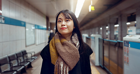 Image showing Smile, walking and young woman at train station for exploring on vacation, adventure or holiday. Happy, travel and beautiful Asian female person by public transport for sightseeing on weekend trip.