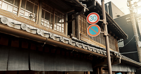 Image showing Architecture, building and road sign on street for city, traditional infrastructure and culture in urban town. Tourism, neighbourhood and signal, symbols and icon for traffic in Japan for travel