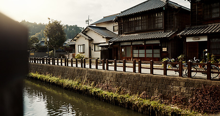 Image showing Houses, building and canal with trees in Japan of architecture, structure or natural scenery in neighborhood. Japanese architecture, home or outdoor street or road of quiet or peaceful town in Tokyo