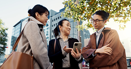 Image showing Phone, business and group of people in city on internet, social media or reading email together in Japan. Smartphone, happy and friends in urban town on technology, networking and mobile app in Tokyo