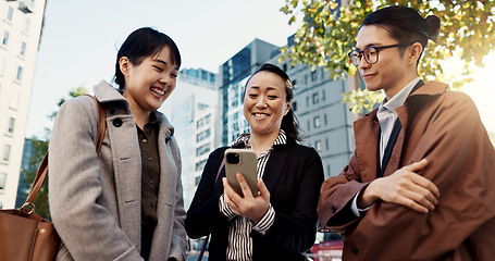 Image showing Phone, smile and Japanese business people in city for travel, communication or networking together. Collaboration, internet or email with happy employee group outdoor for commute in Tokyo town