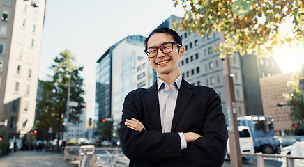 Image showing Japanese lawyer man, portrait and city with arms crossed, pride and smile for job at legal agency. Person, attorney or advocate with suit, street and happy on metro sidewalk, road or outdoor in Tokyo