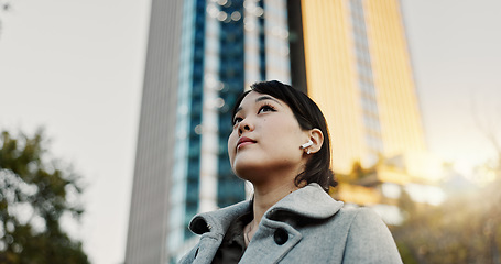 Image showing Thinking, city and business Japanese woman with music on morning commute, travel and walking in Tokyo. Earphones, corporate worker and person with ideas, ambition and future for career, work and job