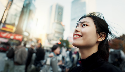 Image showing Walking, travel and Japanese woman in the city for tourist sightseeing in the street on weekend trip. Smile, adventure and happy young female person commuting in road of urban town in Kyoto Japan.