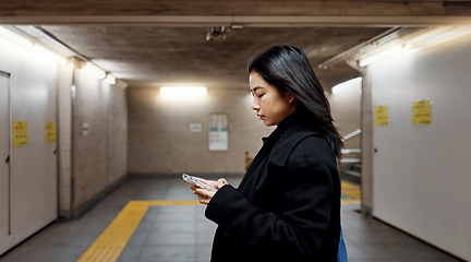 Image showing Phone, subway and Japanese woman on internet, social media and walking to travel in Tokyo. Smartphone, scroll and serious person on app, reading email and information on mobile website on commute