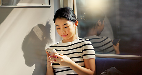 Image showing Asian woman, train and travel with smartphone and communication, commute or adventure with transport. Email, chat and scroll social media with tourism in Japan, public transportation and mobile app