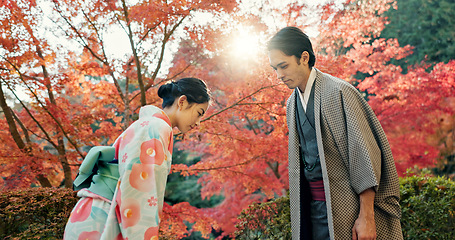 Image showing People in park in Japan, bow and traditional clothes with hello, nature and sunshine with respect and culture. Couple outdoor together in garden, greeting with modesty and tradition, polite and kind