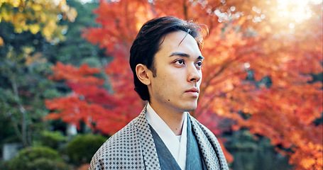 Image showing Man, Asian and walking in garden with sunshine, peace and thinking about life with reflection and tranquility. Travel, tourist in Japanese park and stroll in nature for fresh air, lens flare and calm