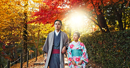 Image showing Japanese people in park, walking and traditional clothes with path, nature and sunshine with respect and culture. Couple outdoor together in garden, date or commitment with love, bonding and calm