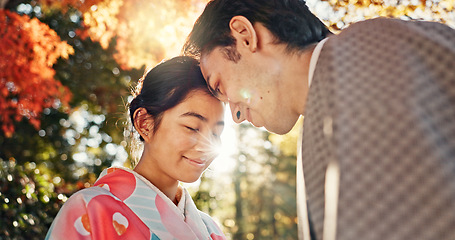Image showing Couple, forehead touch and sunshine with love in park, Japanese people together on date with love and affection. Lens flare, summer and man with woman outdoor, commitment and loyalty with peace