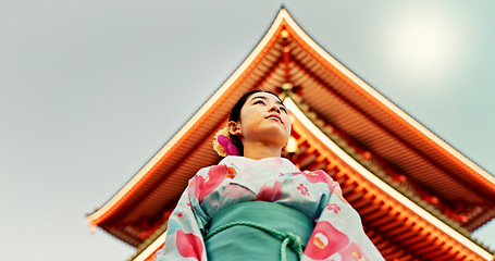 Image showing Woman, Japanese shinto temple and traditional clothes for culture, building or religion in sunshine. Person, ideas and vision for buddhism with faith, mindfulness or thinking with low angle in Kyoto