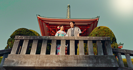 Image showing Man, woman and shinto temple and traditional clothes for culture, building or religion in sunshine. Person, ideas and vision for reflection with faith, mindfulness or buddhism with low angle in Japan
