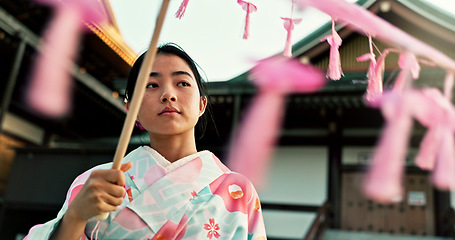 Image showing Asian, woman at temple and parasol, face with tradition and religion, young tourist or local in Tokyo. Traditional clothes, culture and wellness, Japanese with travel and umbrella for sun outdoor