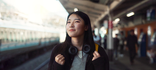 Image showing Asian, woman at train station for travel, commute or holiday with smile on face and freedom outdoor. Railway, walking on platform and transportation, journey for adventure in China with happiness