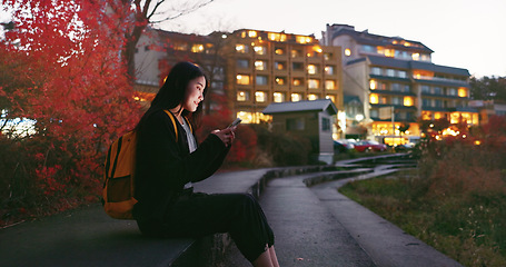 Image showing Asian woman, phone and night at city for social media, communication or outdoor networking. Female person relax on mobile smartphone in the late evening for online chatting in urban town of Japan