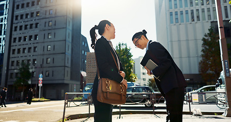 Image showing Asian people in city, professional and bow for greeting with conversation, travel and commute to work in morning. Business man, woman and hello in Tokyo, journey and urban street with communication