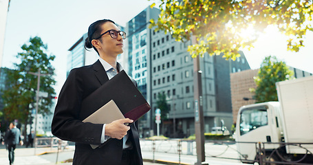 Image showing Walking, city and Asian business man with tablet, documents and file for morning commute in urban town. Professional, corporate worker and person thinking on travel for career, work and job in Japan