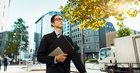 Image showing Walking, city and Asian business man with tablet, documents and file for morning commute in urban town. Professional, corporate worker and person thinking on travel for career, work and job in Japan