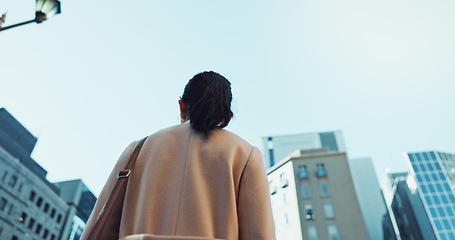 Image showing Woman, Asian in city with travel or commute to work, low angle and professional in Tokyo. Corporate lawyer in urban street, journey to office and business mindset with buildings and view outdoor