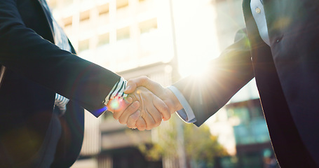 Image showing Business people, handshake and city for partnership, agreement or greeting in outdoor deal or meeting. Closeup of employees shaking hands outside for b2b, teamwork or hiring in an urban town together