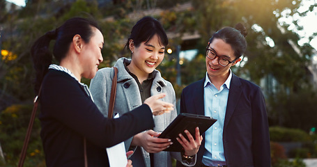 Image showing Tablet, discussion and business people in the city talking for communication or bonding. Smile, conversation and professional Asian colleagues speaking with digital technology in urban town.